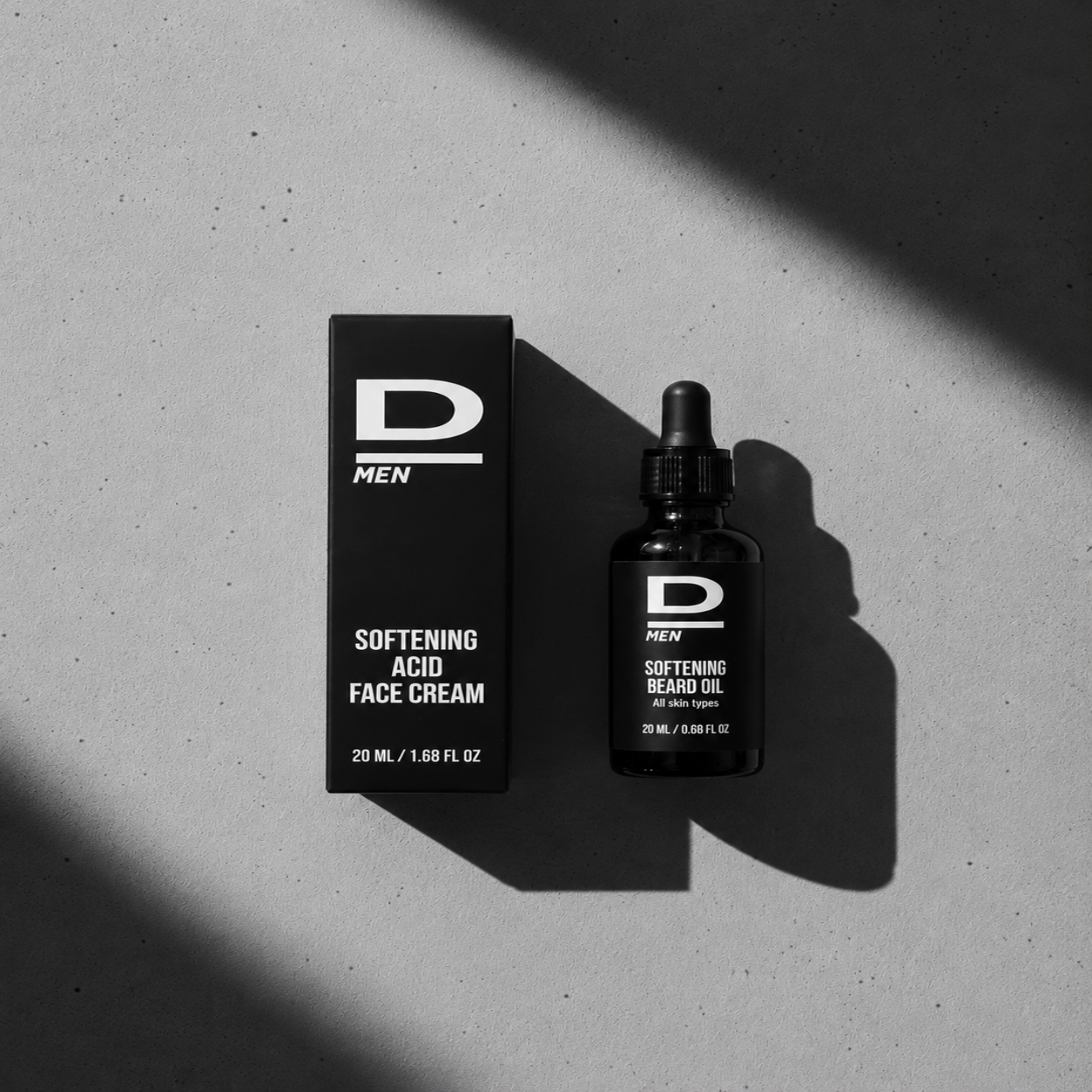 Schwarz-weiße Aufnahme einer Verpackung und einer Flasche mit Pipette für Männerpflegeprodukte mit der Aufschrift 'D MEN SOFTENING ACID FACE CREAM' und 'D MEN SOFTENING BEARD OIL'