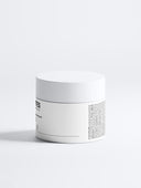 Runder, weißer Behälter mit schwarzem Text. Aufschrift: 'Deportes Icelandic Volcano Face & Body Scrub'. Inhalt: 170 ml.