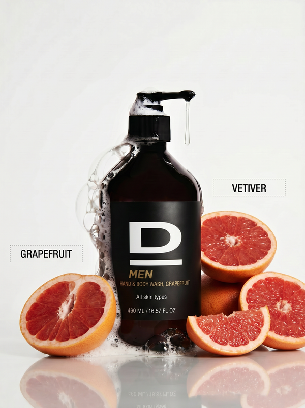 Flasche D MEN Hand- und Körperwaschmittel Grapefruit mit Schaum und Grapefruitstücken daneben