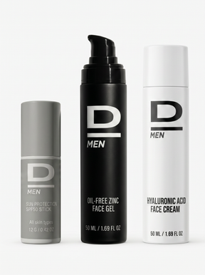 Drei D MEN Hautpflegeprodukte in grauem, schwarzem und weißem Spender mit Beschriftungen zu Sonnenschutz, Gesichts-Gel und Gesichtscreme